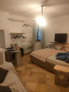 a bedroom with a bed and a desk and a television at La casa di Noah in Montecatini Terme