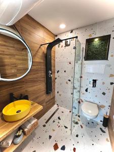 a bathroom with a rock wall and a shower at Stracciatella Homes Apartment in Sofia