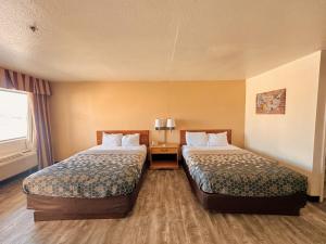 a hotel room with two beds and a window at Econo Lodge Lordsburg I-10 in Lordsburg