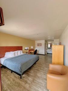 a hotel room with a bed and a chair at Econo Lodge Lordsburg I-10 in Lordsburg