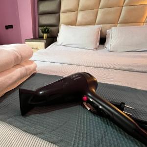 a vacuum cleaner laying on a bed in a bedroom at Casablanca Central Suites - Casa Port in Casablanca