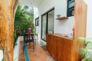 a bathroom with a sink and a wooden counter at Maison Bacalar in Bacalar
