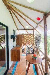 a living room with a table and a table at Maison Bacalar in Bacalar