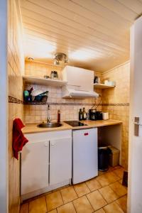 a kitchen with white cabinets and a sink at Sublime Studio - Centré & Tout Equipé in Grenoble