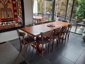 a wooden table and chairs in a room at Executive Home in Kaikoura