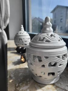 two white vases sitting on a table with a window at Cozy Charming Theresa in Schmelz