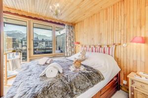 a bedroom with a large bed with a window at Résidence Lot b - Pièces 271 in Tignes