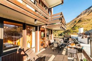 a balcony with a table and chairs and a mountain at Résidence Lot b - Pièces 271 in Tignes