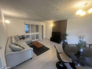 a living room with a couch and a glass table at Canterbury Escapes 2 bedrooms in Kent