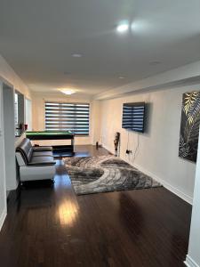 a living room with a pool table and a couch at Bellhaven Beautiful Home in Brampton