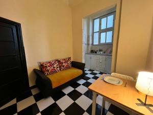 a living room with a couch and a checkered floor at Casablanca Central Suites - Casa Port in Casablanca