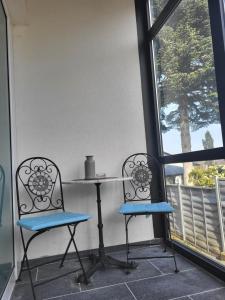 two chairs and a table in front of a window at Lovely Oasis in Schmelz