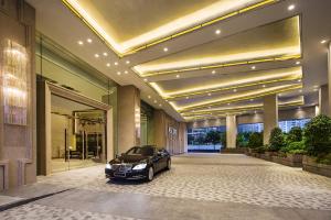 a black car parked in a building with a garage at Ascott Macau in Macau