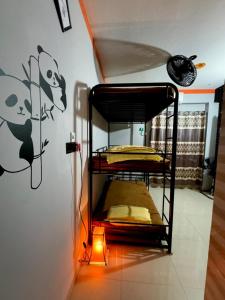 a bedroom with two bunk beds and a lamp at zooFamily in Dhaka