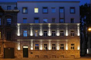 a building lit up at night with lights at MyApartments in Tallinn