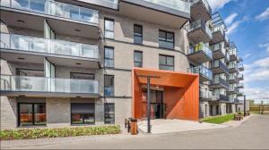 an exterior view of a building with an orange object at Welcome Gdańsk Apartments Nadmotławie Gym and Sauna in Gdańsk