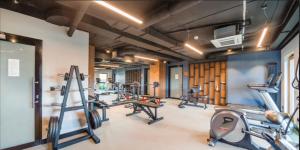 a gym with several treadmills and cardio machines at Welcome Gdańsk Apartments Nadmotławie Gym and Sauna in Gdańsk