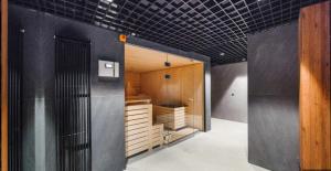 a kitchen with wooden cabinets and a black tiled ceiling at Welcome Gdańsk Apartments Nadmotławie Gym and Sauna in Gdańsk +13 photos
