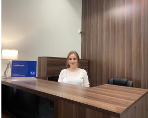 een vrouw aan een bureau in een kantoor bij Hotel Donald in Odessa