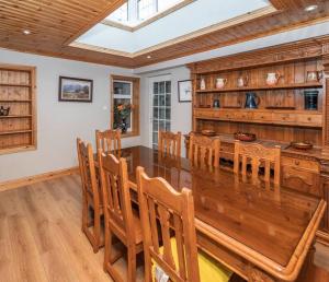 a dining room with a large wooden table and chairs at Mullally House Liscannor (Wild Atlantic Way) in Liscannor