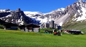 a group of people in a field in front of a mountain at Chalet Pre Saint-jacques - Chalets pour 15 Personnes 601 in Tignes