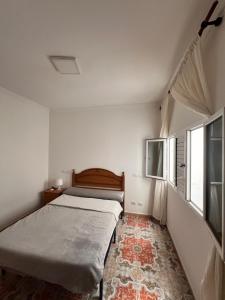 Ein Bett oder Betten in einem Zimmer der Unterkunft La dolce Arinaga