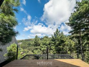 a view from the deck of a house with trees at Chales Naturale - Campos do Jordão - CNA in Campos do Jordão