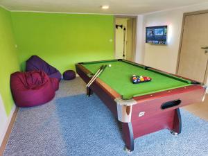 a room with a pool table in a room at Leśny Zakątek in Gdańsk