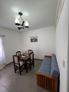 a living room with a couch and a table with chairs at Departamento Mis Nonos 3 in Mendoza +13 photos