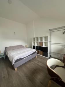 a bedroom with a bed and a chair and a desk at 2 pièces duplex Issy Les Moulineaux in Issy-les-Moulineaux
