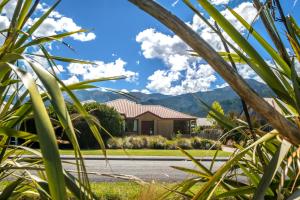 a house with mountains in the background at 20 Rippingale Road in Hanmer Springs