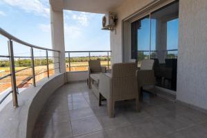 a balcony with a table and chairs on a balcony at Villa Dhaouia torki in Kelibia