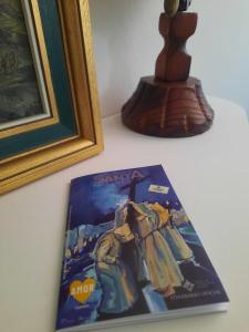 a book sitting on a table next to a picture at Apartamento Candelaria in Zamora