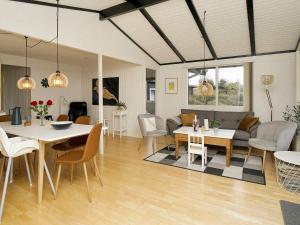 a living room and dining room with a table and chairs at Holiday home Ølsted III in Ølsted