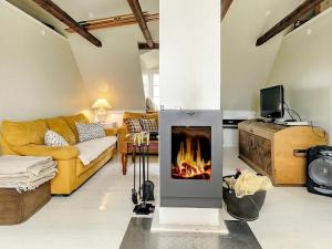 a living room with a fireplace in the middle at 6 person holiday home in Søby Ærø-By Traum in Havrekobbel