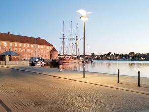 una luz de la calle junto a un cuerpo de agua con barcos en 4 person holiday home in S nderborg en Sønderborg