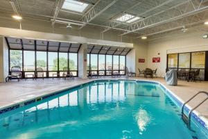 a swimming pool with blue water in a building at Drury Inn and Suites St Louis Collinsville in Collinsville