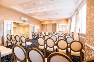 an empty room with rows of chairs in a row at Thames Riviera Hotel, Sure Hotel Collection by Best Western in Maidenhead