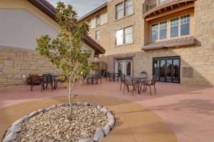 a courtyard with a tree in a large pot at Drury Inn & Suites Las Cruces in Las Cruces