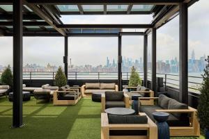 a living room with a view of the city at Arlo Williamsburg in Brooklyn