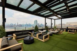 a living room with a view of a city at Arlo Williamsburg in Brooklyn