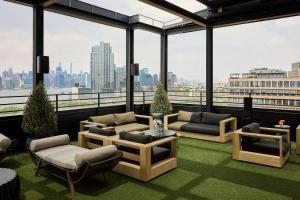 a living room with a view of a city at Arlo Williamsburg in Brooklyn