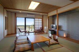 a living room with a table and chairs at Senri no Kaze in Tateyama