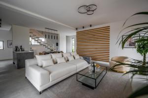 een woonkamer met een witte bank en een tafel bij Villa LiLa - Sunshine in Marčana