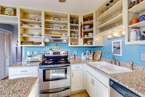 a kitchen with a stove and a sink at Crystal Coast Charmer in Atlantic Beach