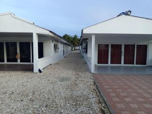 two white buildings with doors and a courtyard at Mary playas coveñas in Coveñas