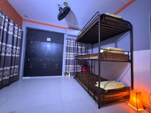 a room with bunk beds in a room with a door at zooFamily in Dhaka