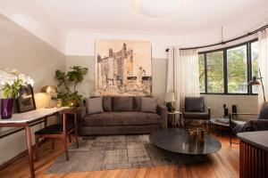 a living room with a couch and a table at Hotel Edificio Republica in Mexico City +1 photo