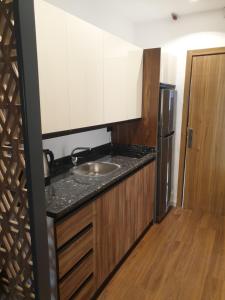 a kitchen with a sink and a refrigerator at Luxury Studio Apprtement in Hurghada