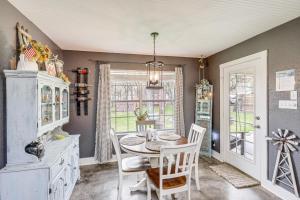 a dining room with a table and chairs and a window at 5 Mi to Belton Lake Peaceful Home with Hot Tub in Belton